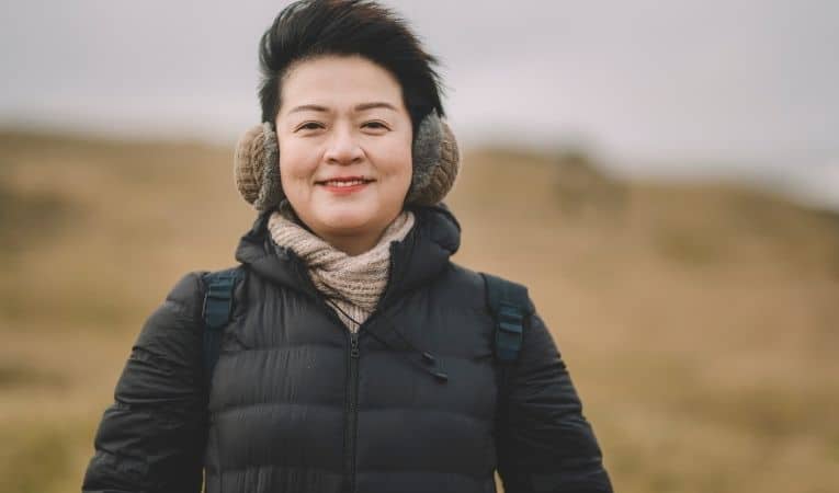 Asian woman staying warm in Iceland